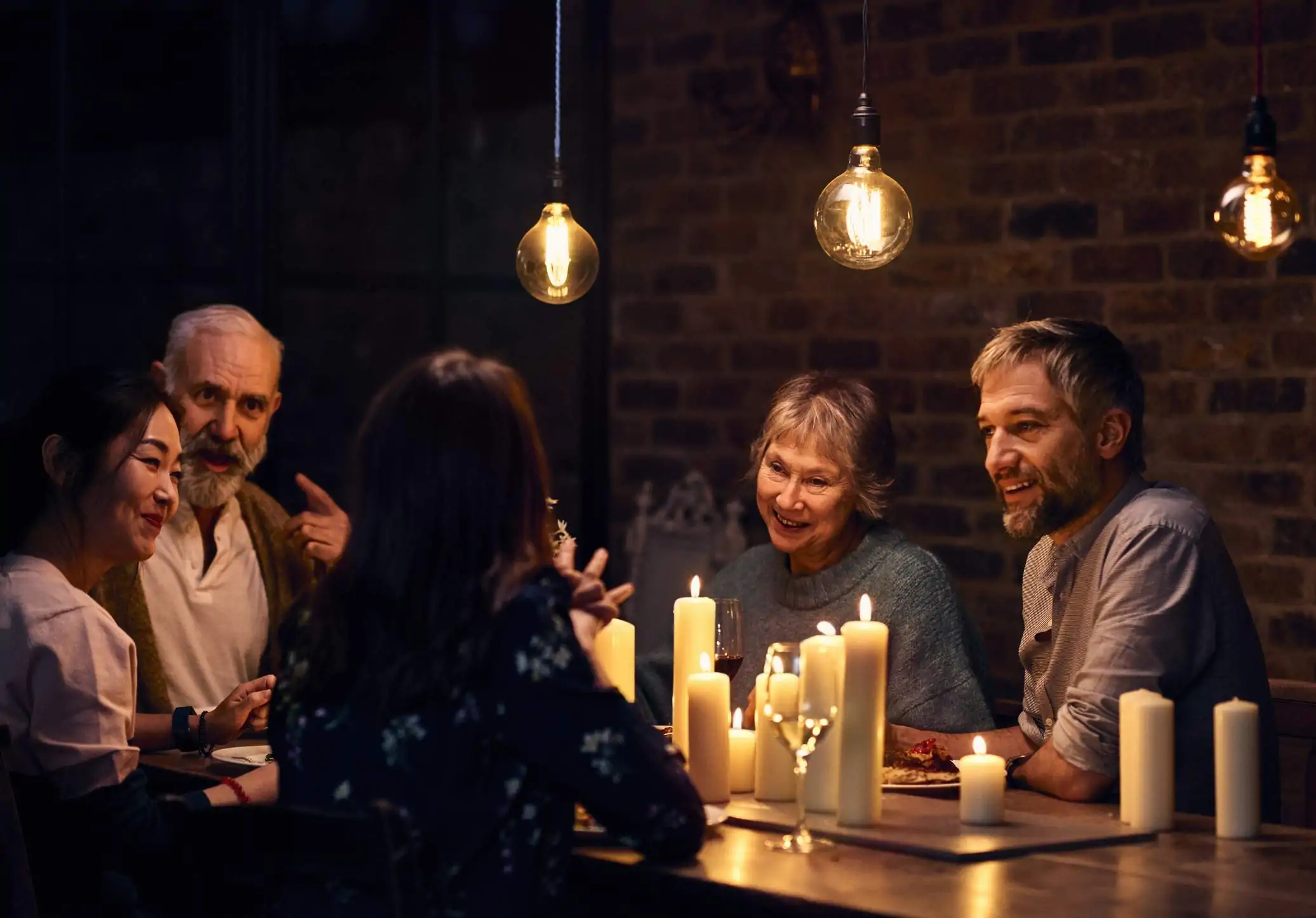 Image depicts a group of people at a private dining event in a restaurant.