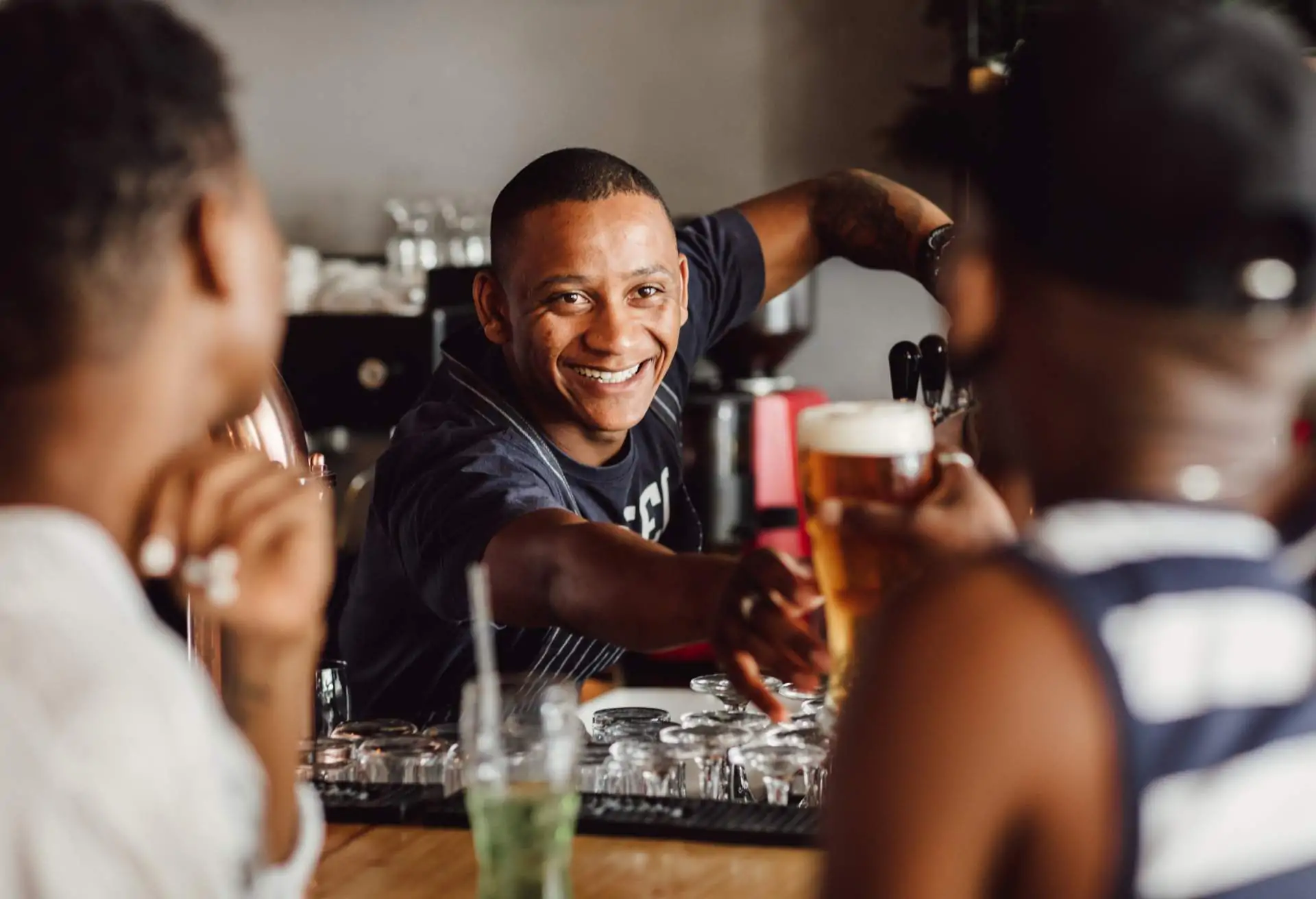 Friendly faces around a restaurant bar