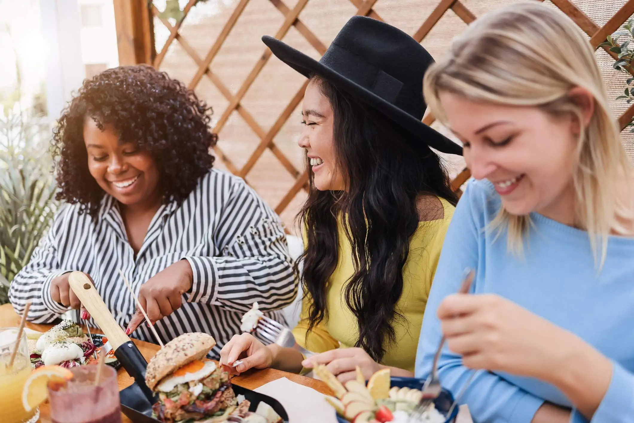 Image depicts a group of people sharing brunch at a restaurant.