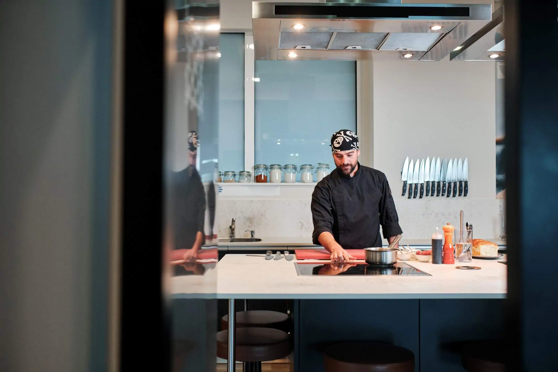 Image depicts a chef turning on an induction stove.