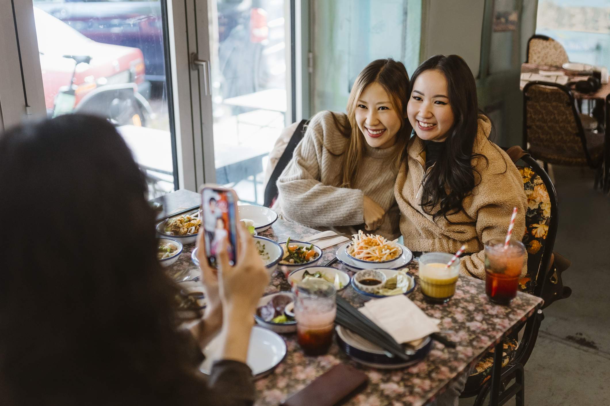 Social media influencers taking selfies at a restaurant