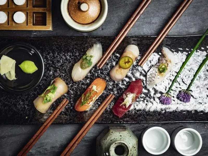 Image depicts sushi on a tray.