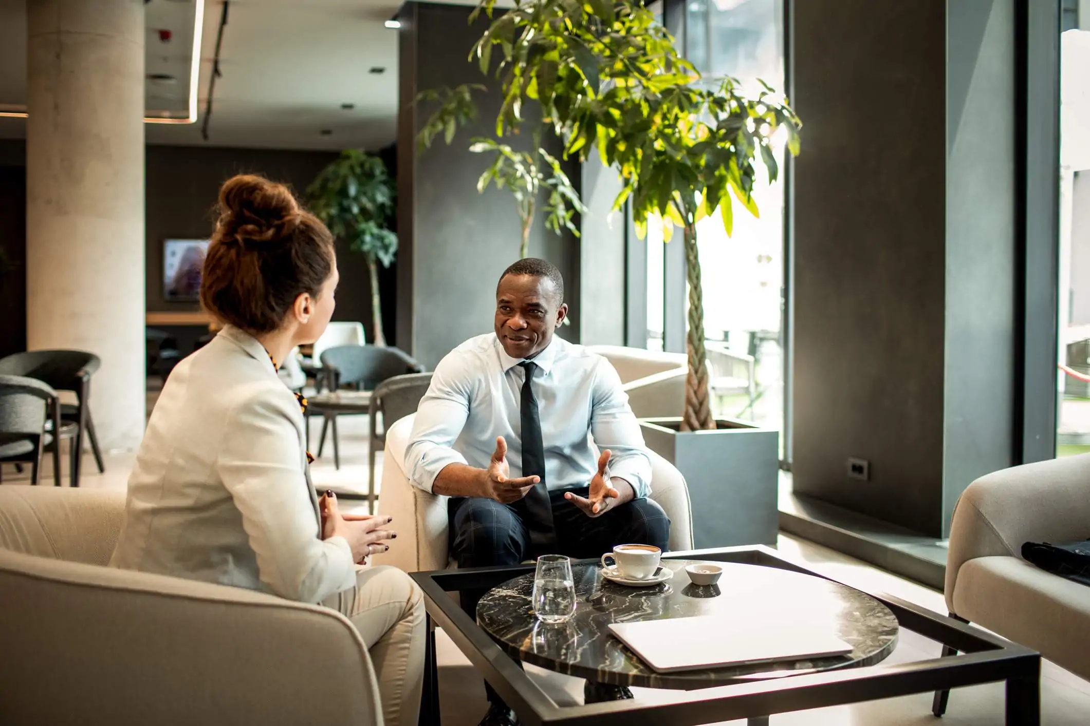 Image depicts two restaurant workers having a discussion.