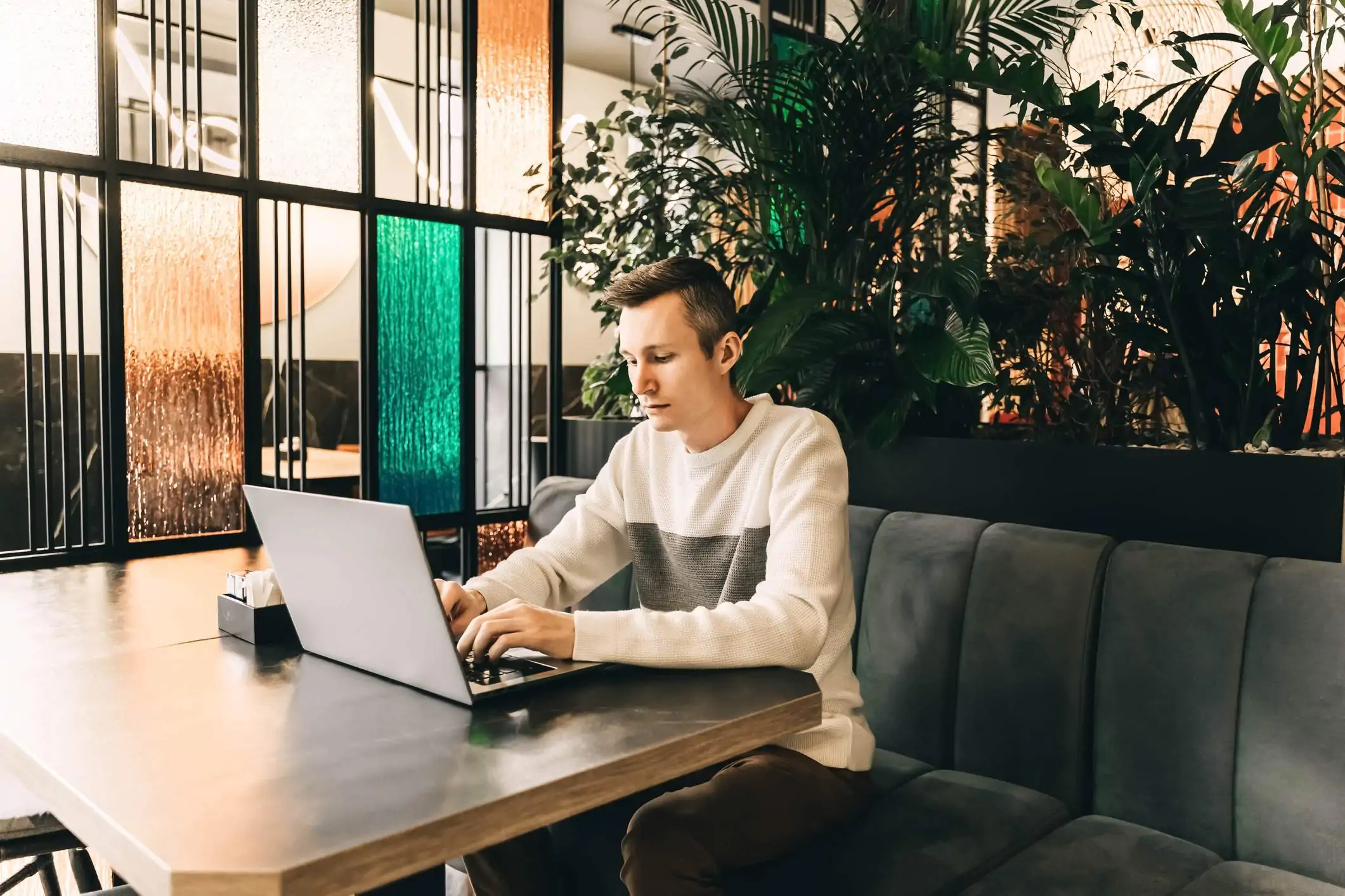 Image depicts a restaurant worker using a computer