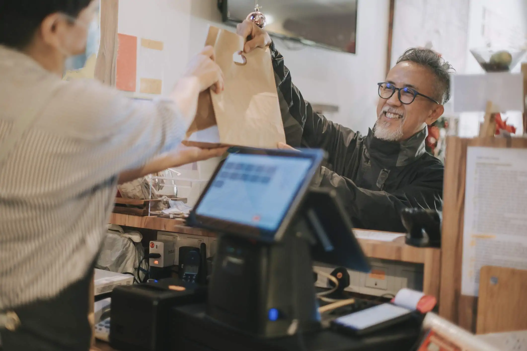 Image depicts a delivery driver picking up takeout.