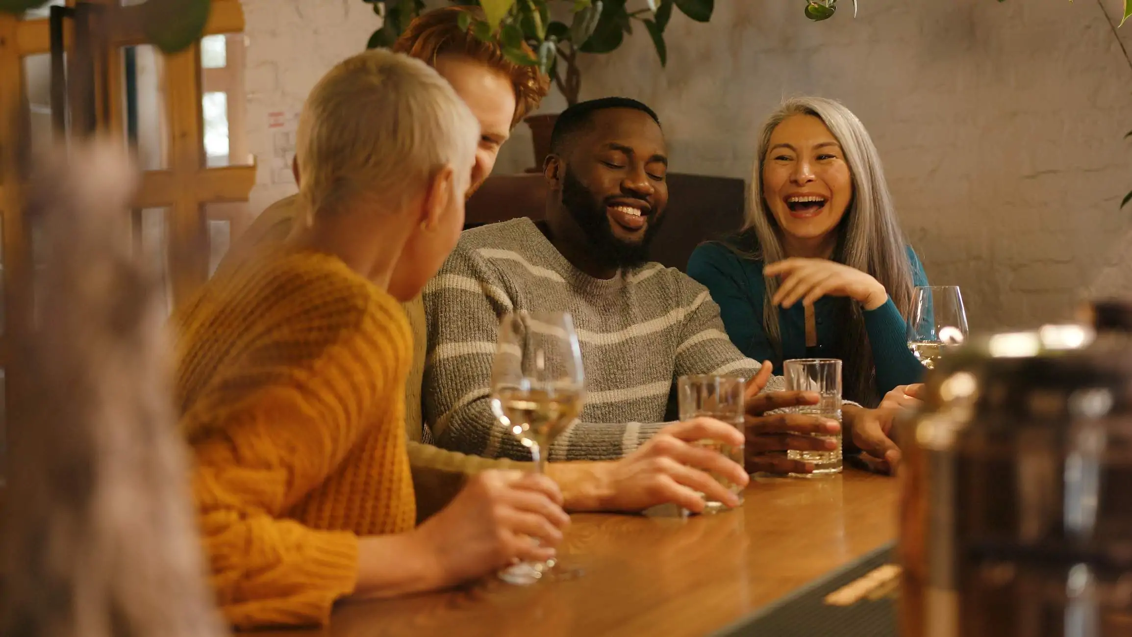 Image depicts a group of people dining at a restaurant.