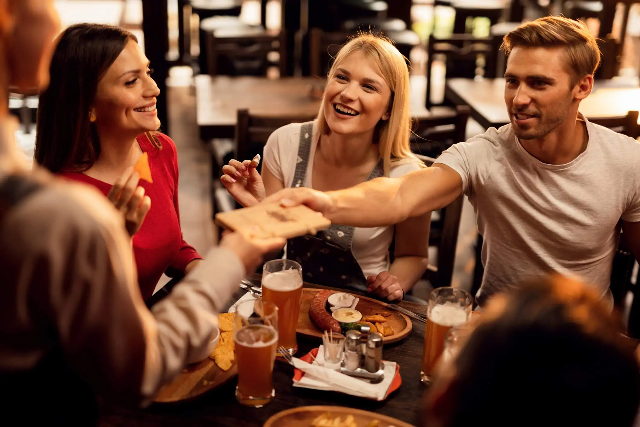 Image depicts a group of diners at a restaurant.