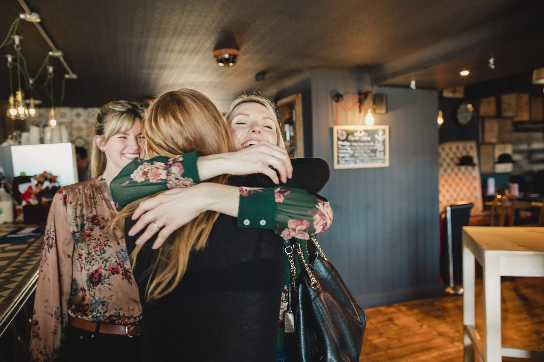 Image depicts a group of diners greeting each other.