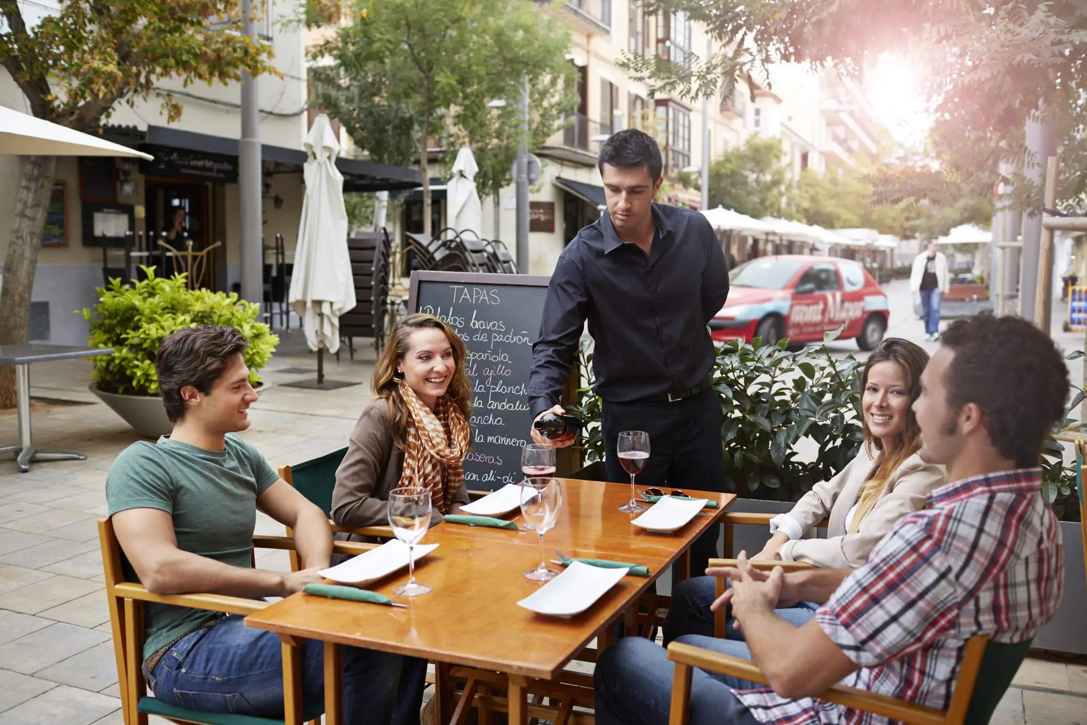 Image depicts guests dining outside at a restaurant.