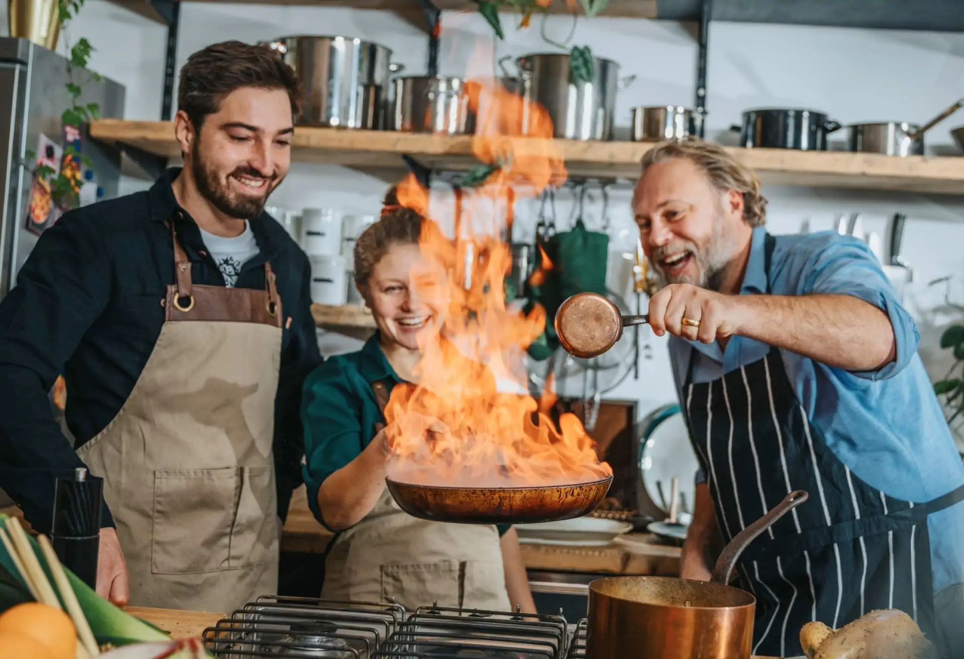 Restaurants workers happily collaborating over the stove in a professional kitchen