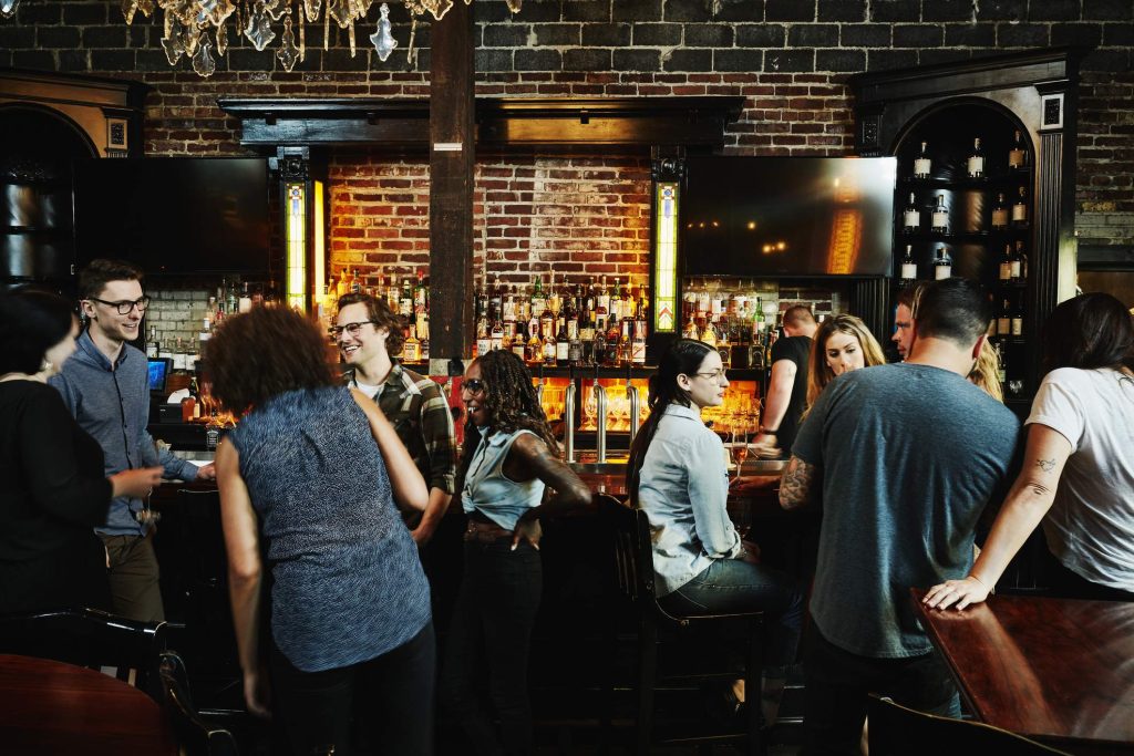 Image depicts a crowded bar.