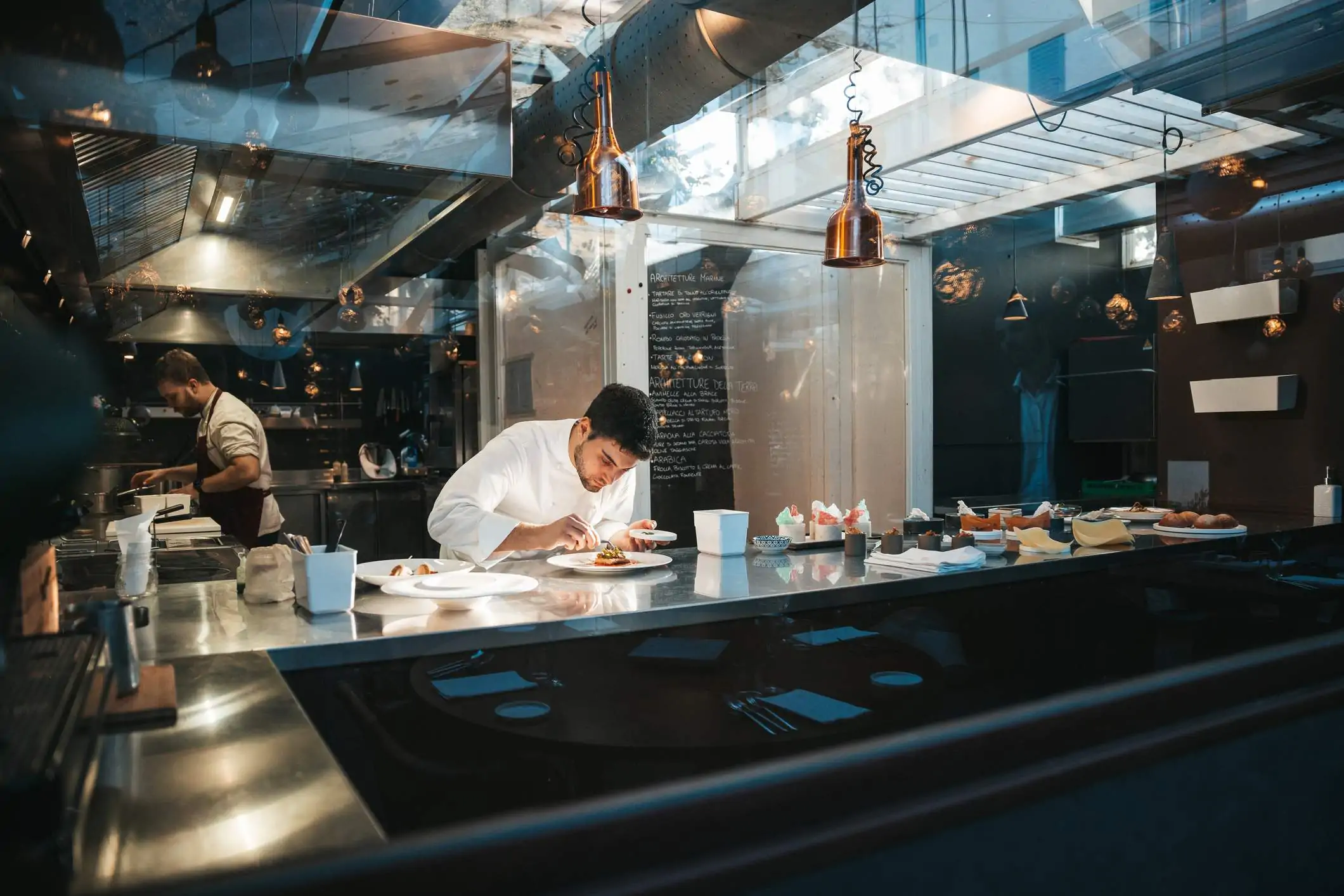 Image depicts a restaurant worker behind the counter.